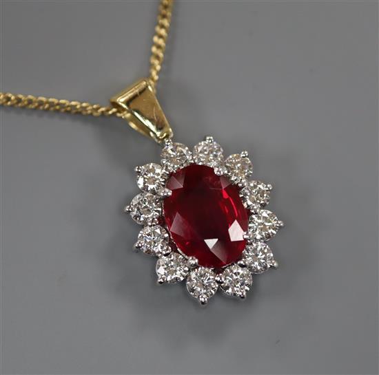 An 18ct gold and platinum ruby and diamond cluster pendant on 18ct gold fine chain, pendant 12mm.